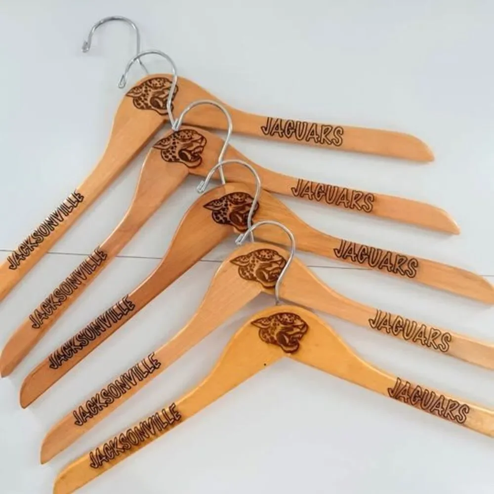 5 custom wood hangers with Jacksonville Jaguars branding.
